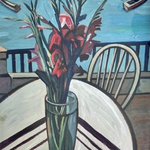 Painting of a vase of flowers on a table beside the sea